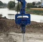 Excavator mounted solar pile driver for solar panel construction project