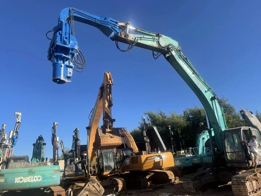 Excavator mounted solar pile driver for solar panel construction project