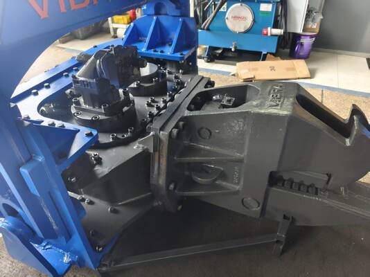 Hydraulic Pile Driver with Integrated Control Valve Assembly and Dual Pump Flow Merging System
